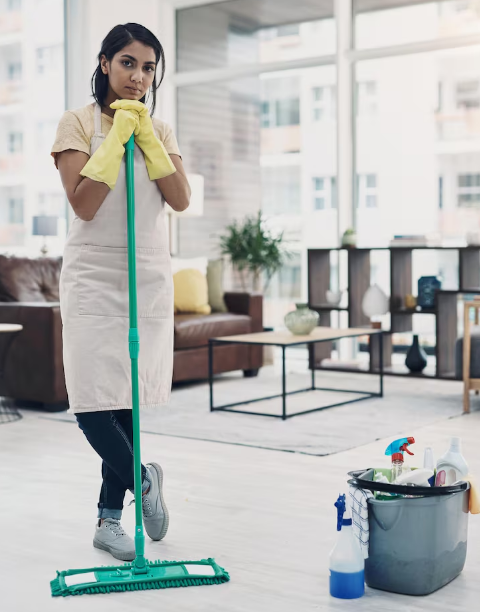 Professional cleaner posing with a mop in a clean living room